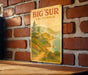 a picture of a big sur california sign on a brick wall