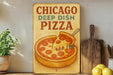 a sign that says chicago deep dish pizza