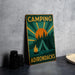 a camping sign sitting on top of a table