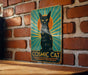 a picture of a black cat on a brick wall