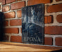 a picture of a woman sitting on top of a wooden table
