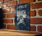 a picture of janus on a brick wall