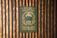 a close up of a sign on a wooden wall