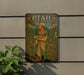 a painting on the side of a building with a plant in front of it
