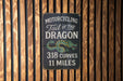 a sign on the side of a wooden building