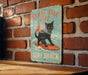 a picture of a cat on a surfboard on a brick wall