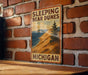 a sign on a brick wall that says sleeping bear dunes michigan