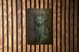 a picture of a cat on a wooden wall