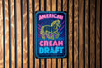 a neon sign that says american cream draft