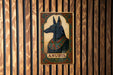 a picture of anubis on a wooden wall