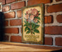 a picture of a flower on a brick wall