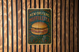 a sign on a wooden wall advertising a new orleans restaurant
