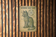 a sign on a wooden wall that says atomic age cat