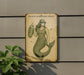 a picture of a mermaid on a wall