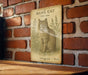 a picture of a cat on a sign on a brick wall