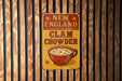 a sign on a wooden wall that says new england clam chowder