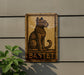 a sign on the side of a building with a cat on it