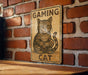 a sign on a brick wall that says gaming cat
