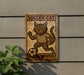 a wooden sign with a picture of a cat on it