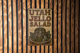 a sign on a wooden wall that says utah jello salad