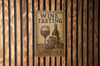 a wine tasting sign on a wooden wall