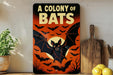 A sign with the text "A COLONY OF BAT" and an illustration of a bat against a bat-filled sky, with a wooden cutting board and lemons in the background.