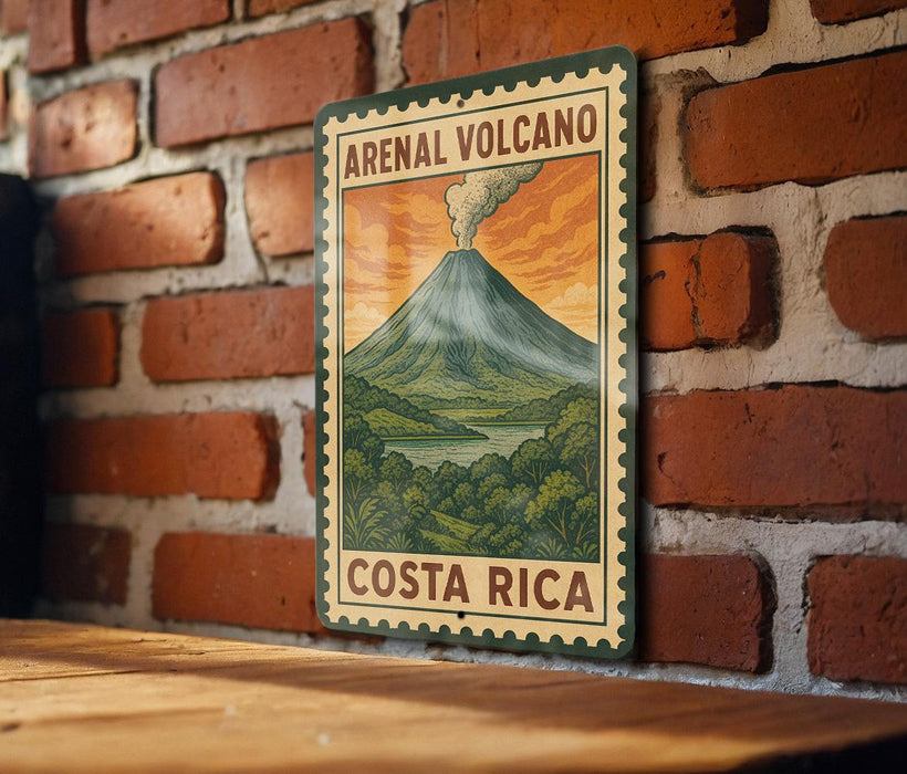 A vintage-style metal sign with the text "ARENAL VOLCANO" and "COSTA RICA" is displayed on a brick wall.