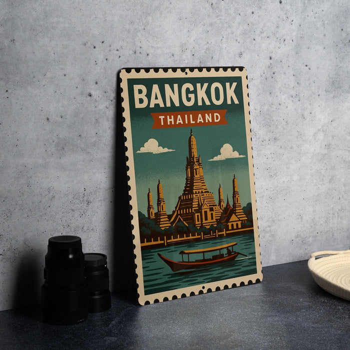 A vintage-style metal sign with the text "BANGKOK THAILAND" and an illustration of the Wat Phra Mahathat, a famous temple in Bangkok, Thailand.