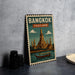 A vintage-style metal sign with the text "BANGKOK THAILAND" and an illustration of the Wat Phra Mahathat, a famous temple in Bangkok, Thailand.