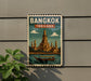 A vintage-style poster of the Wat Phra Mahathat temple in Bangkok, Thailand, displayed on a wall.