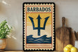 A vintage-style sign for Barbados, featuring a trident symbol, is displayed on a shelf next to a wooden cutting board and a potted plant.