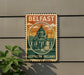A vintage-style sign that reads "Belfast Northern Ireland" with an illustration of a building and a dome, mounted on a wall.