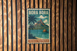 A vintage-style poster of Bora Bora, a tropical island in French Polynesia, is displayed on a wooden wall.