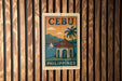 a vintage-style poster of Cebu, the capital city of the Philippines, with a tropical beach scene and a boat in the background.