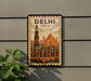 A vintage-style poster of the Qutub Minar, a famous monument in Delhi, India, is displayed on a wall.
