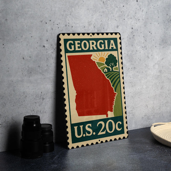 A metal sign with a red state of Georgia on it, featuring a green border and the text "GEORGIA U.S. 20c".