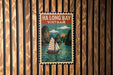 A vintage-style poster of Ha Long Bay, Vietnam, featuring a sailboat on the water and surrounded by mountains.