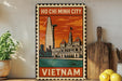 A vintage-style metal sign depicting Ho Chi Minh City, Vietnam, with a tall skyscraper and a building with a clock tower, set against a colorful sky.
