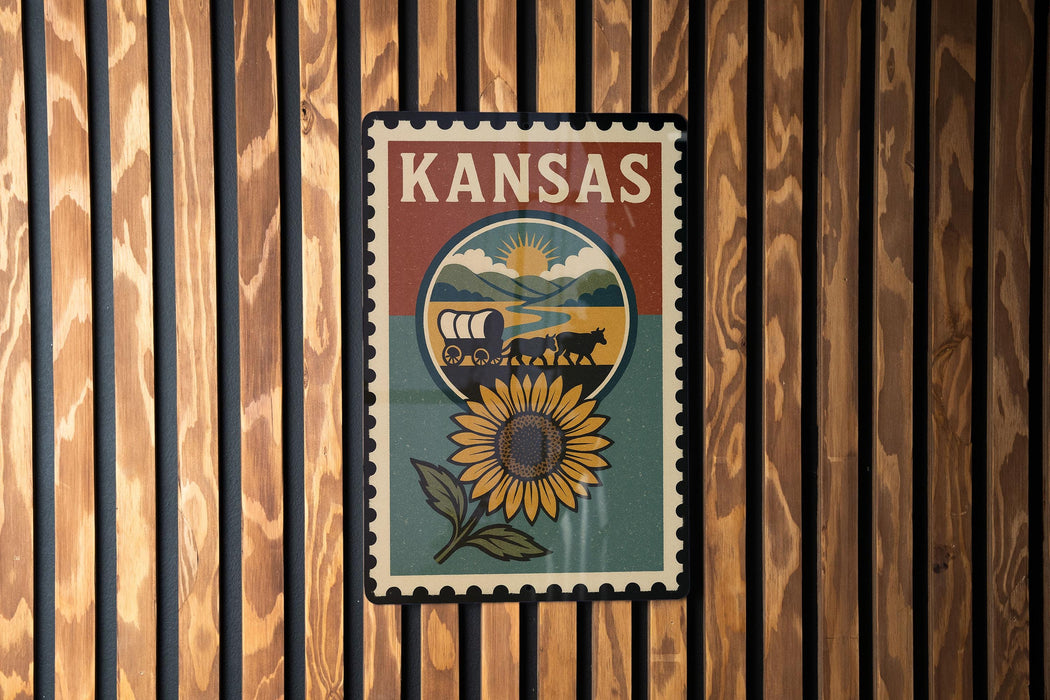 A vintage-style poster of Kansas, featuring a sunflower and a wagon, is displayed on a wooden wall.
