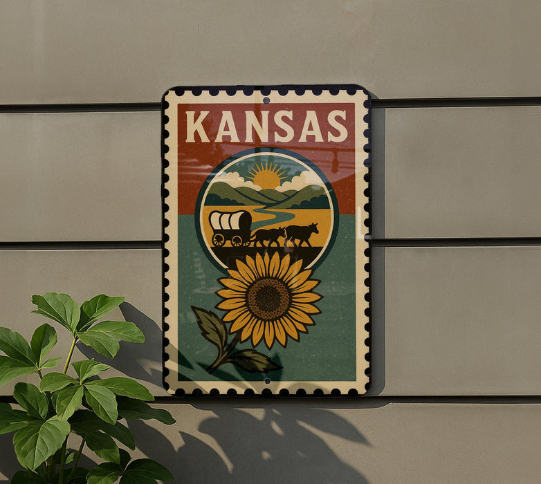 A decorative metal sign with the word "KANSAS" on it, featuring a sunflower and a wagon on a dirt road.