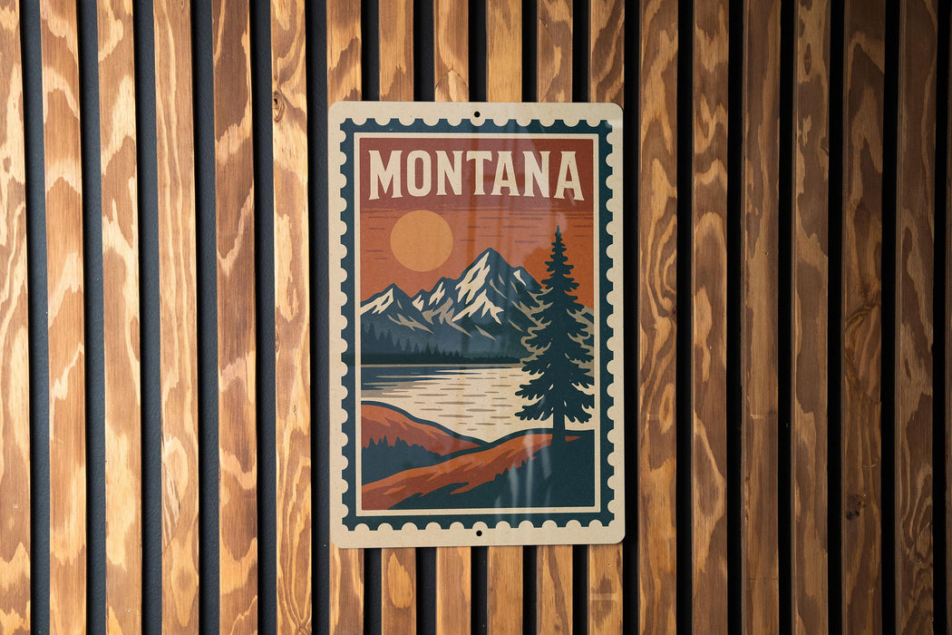 A vintage-style metal sign with the word "MONTANA" prominently displayed, featuring a mountain landscape with a pine tree and a lake.