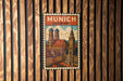 A vintage-style postage stamp depicting the city of Munich, Germany, with the text "MÜNICH GERMANY" prominently displayed.