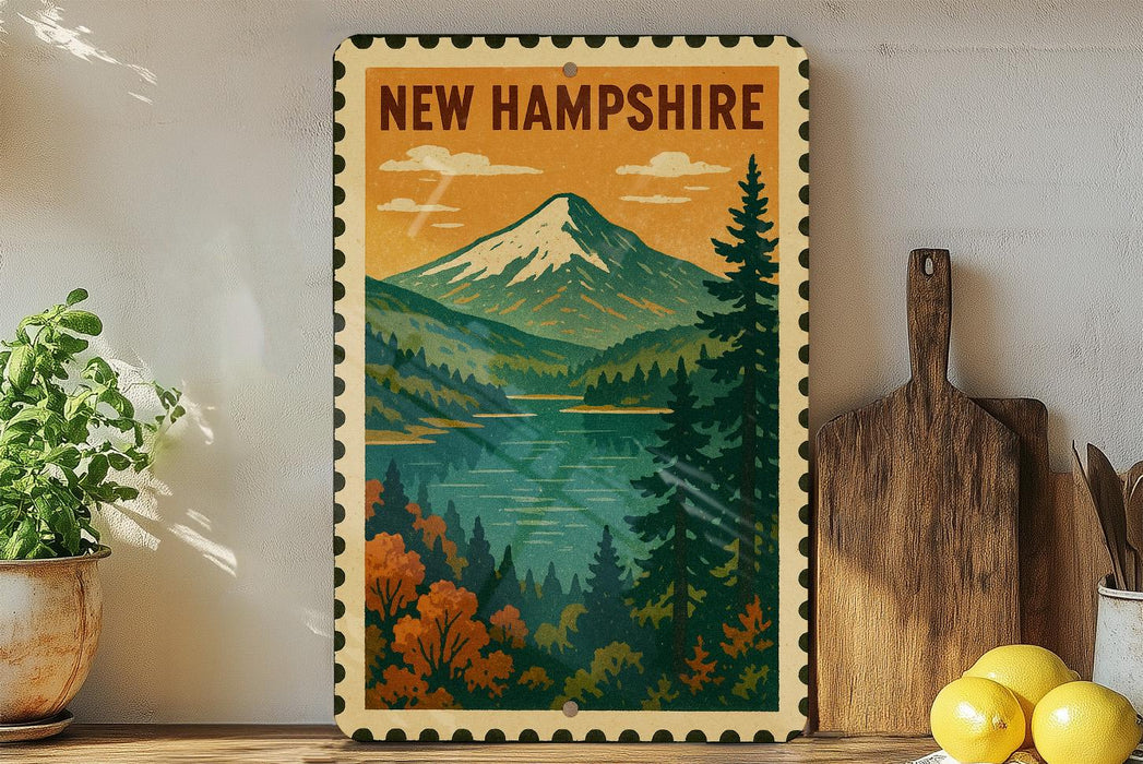 A framed vintage postcard depicting a scenic mountain landscape with a lake, surrounded by pine trees and autumn foliage, is displayed on a shelf next to a wooden cutting board and a potted plant.