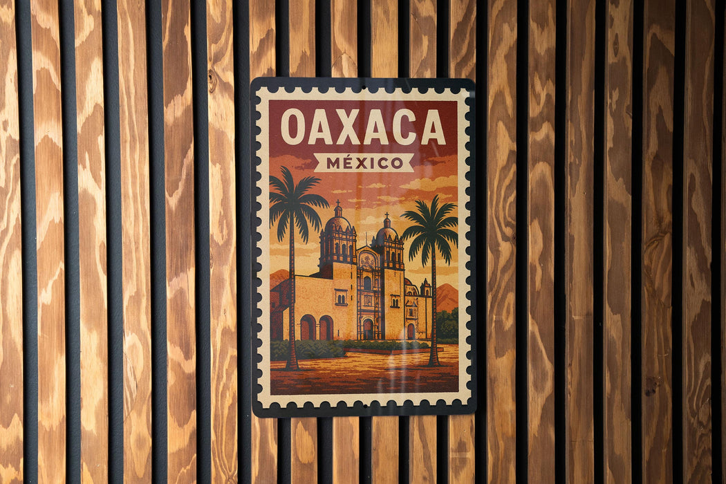 A vintage-style poster of Oaxaca, Mexico, featuring a building with a dome and palm trees, is displayed on a wooden wall.