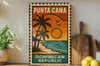 A vintage-style poster of Puna Cana, the Dominican Republic, featuring a tropical beach scene with palm trees and a sunset.