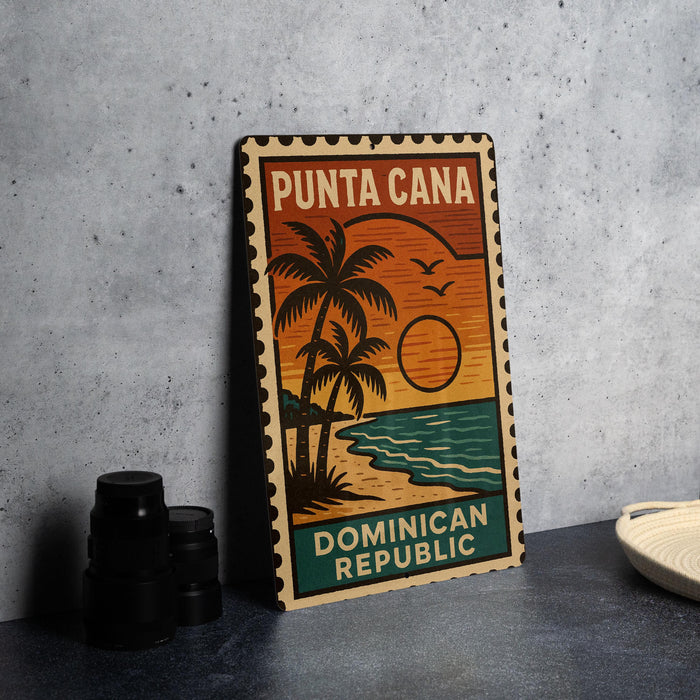 A vintage-style metal stamp depicting a tropical beach scene with palm trees, a sunset, and the text "PUNTA CANA" and "DOMINICAN REPUBLIC".