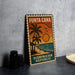 A vintage-style metal stamp depicting a tropical beach scene with palm trees, a sunset, and the text "PUNTA CANA" and "DOMINICAN REPUBLIC".