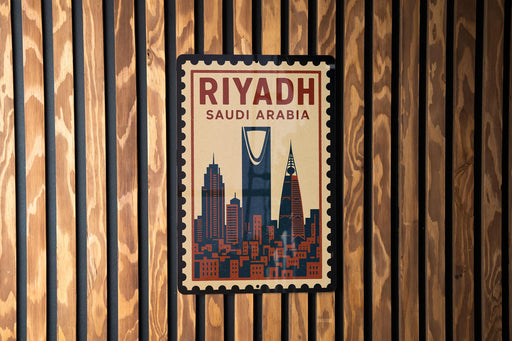 A poster of the skyline of Riyadh, Saudi Arabia, displayed on a wooden wall.