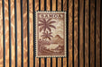 A postage stamp from Samoa is displayed against a wooden background.