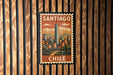 A vintage postage stamp depicting the city of Santiago, Chile, with mountains in the background.